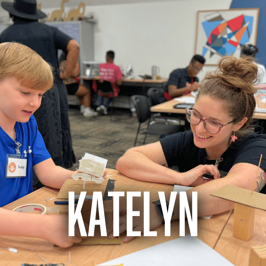 Hub Educator Katelyn Cartwright helps a young boy problem solve as he creates a cranky contraption book that opens and closes as he turns the handle.
