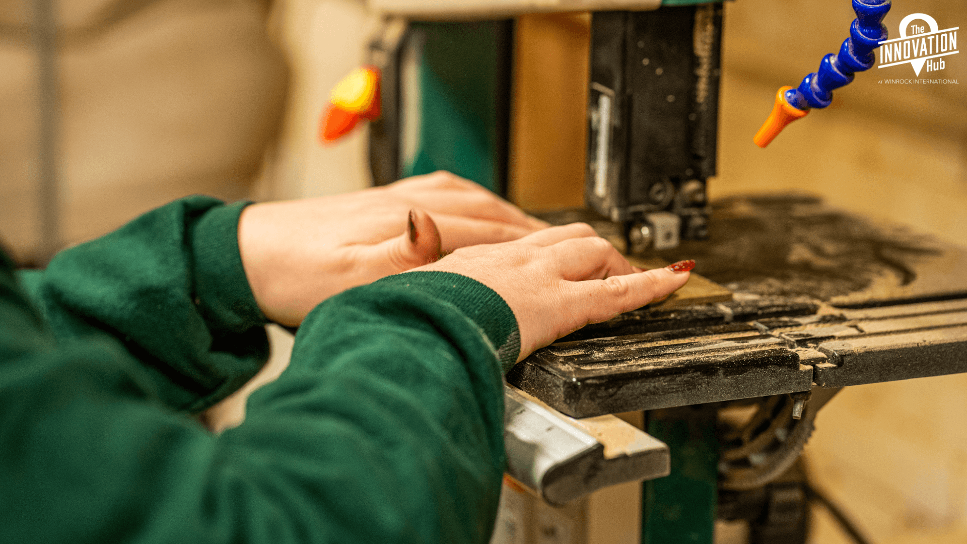 Someone using a pottery wheel and they are shaping a vessel