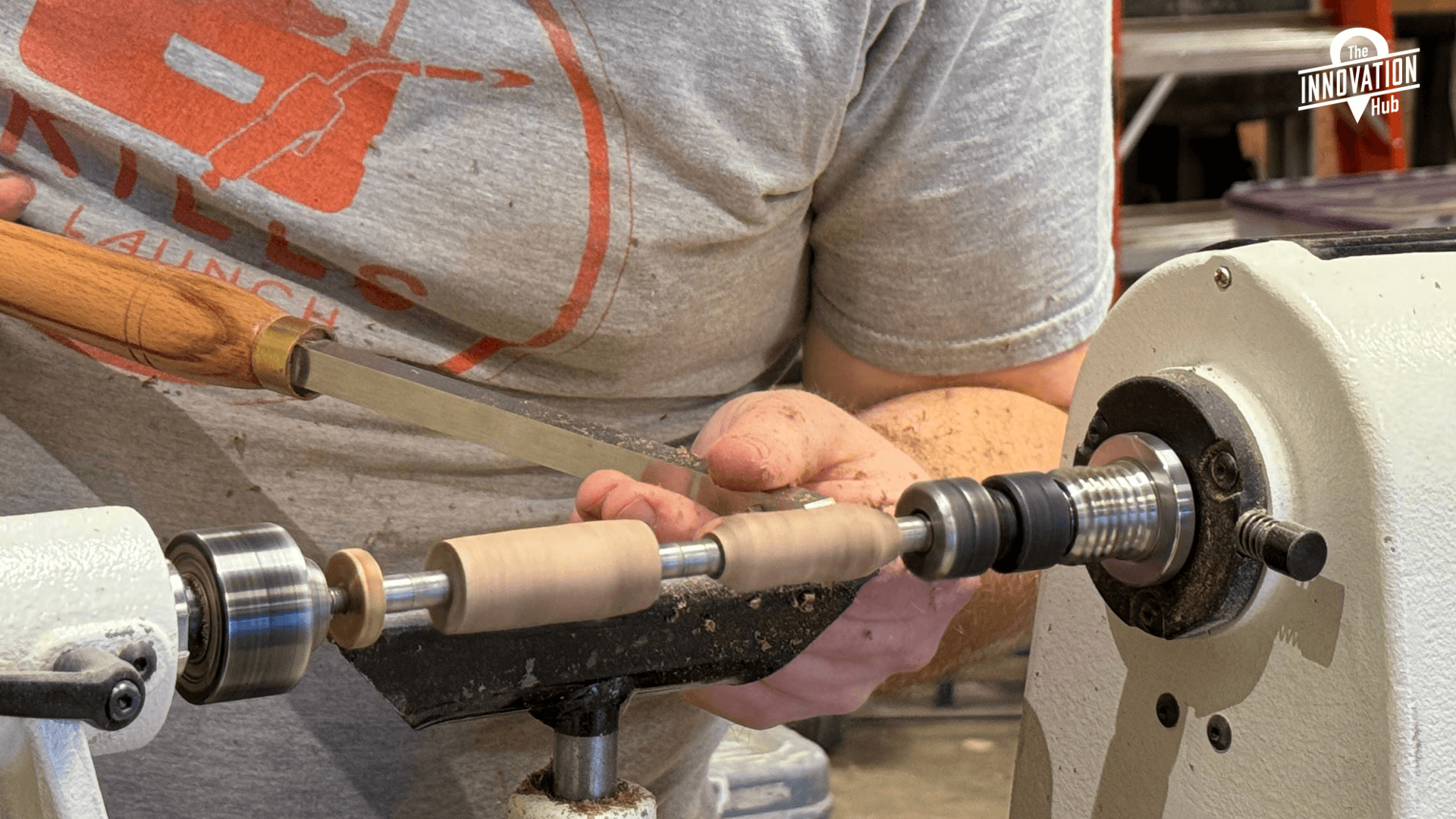 Someone using a pottery wheel and they are shaping a vessel